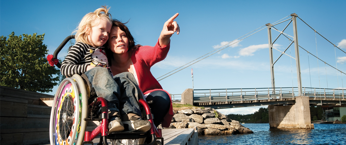 A mother with her daughter in a wheelchair.